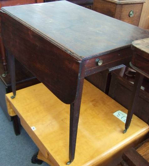 An early 19th century mahogany Pembroke table with single frieze