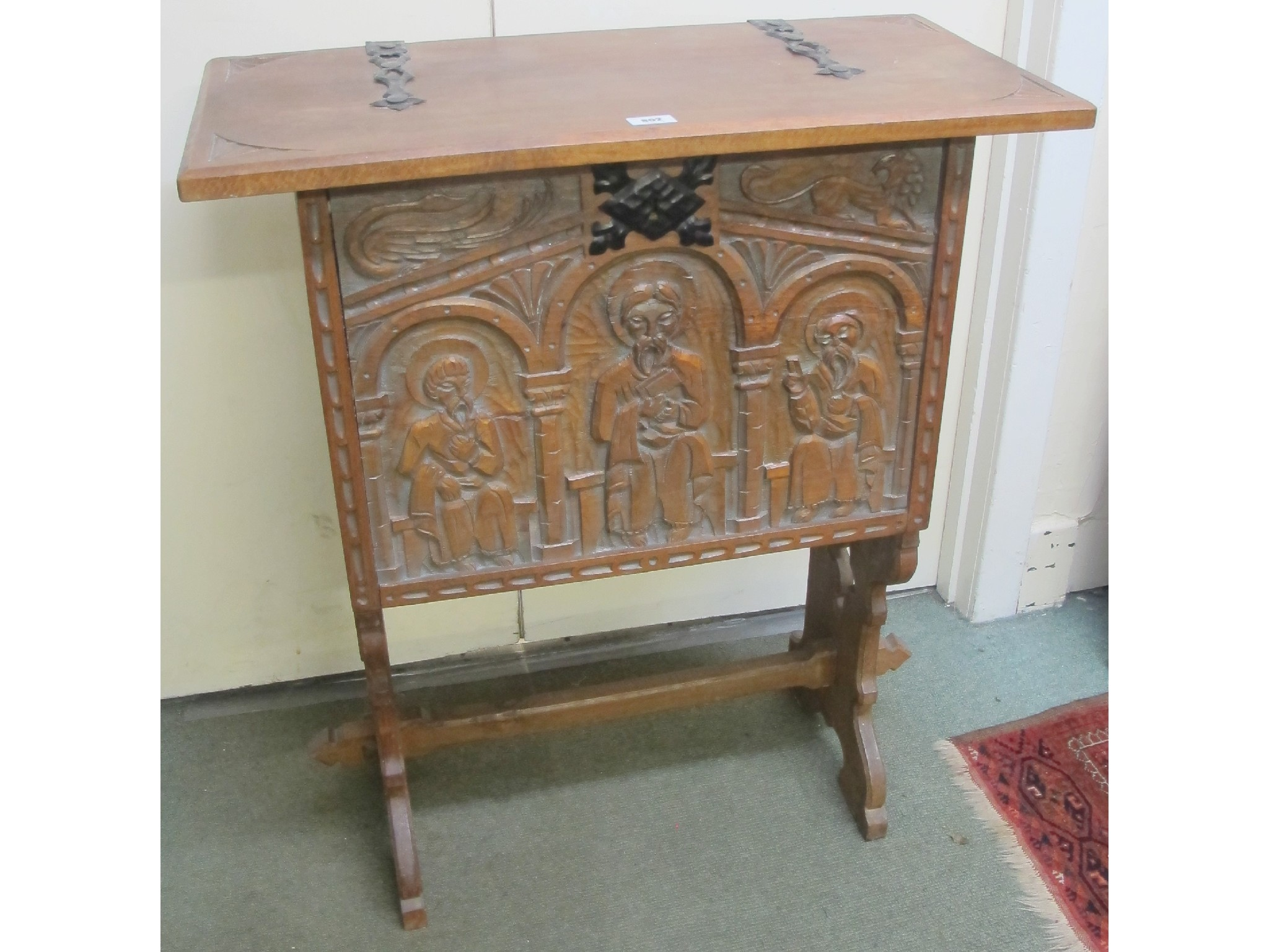 An oak carved ecclesiastical box joined by a stretcher