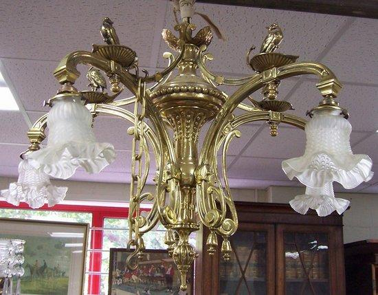 A five branch brass chandelier circa 1900 the scrolling arms