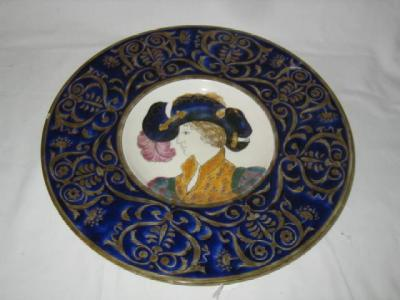 A FISCHER POTTERY PLAQUE of circular form the centre painted