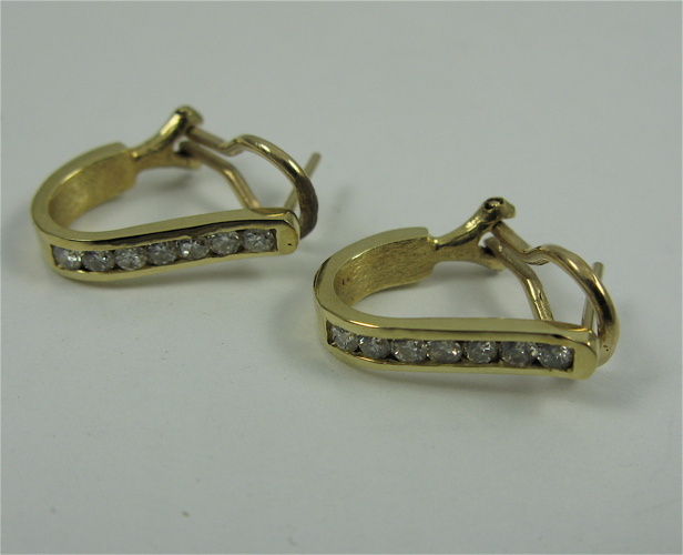 PAIR OF DIAMOND AND 10K GOLD EARRINGS each with seven