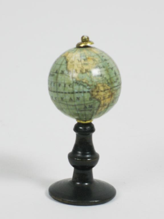 A miniature Revolving Globe on ebonised column 2 1 4in