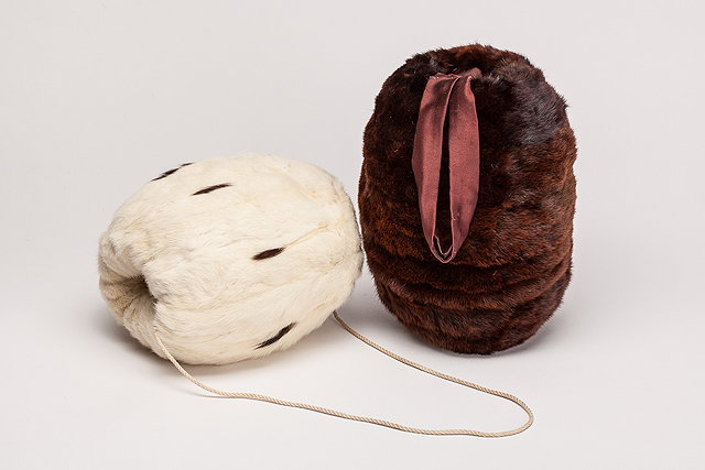 An antique white and black Ermine fur muff rope tie