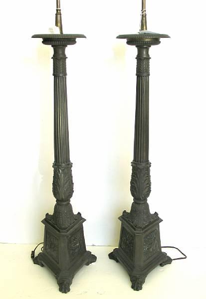 A pair of Neoclassical style bronze candle prickets second half