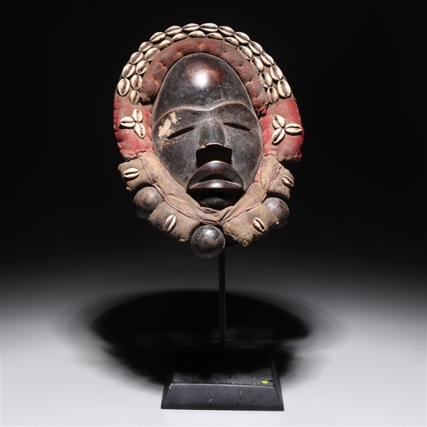 Elaborate West African carved wood Dan mask with fabric and
