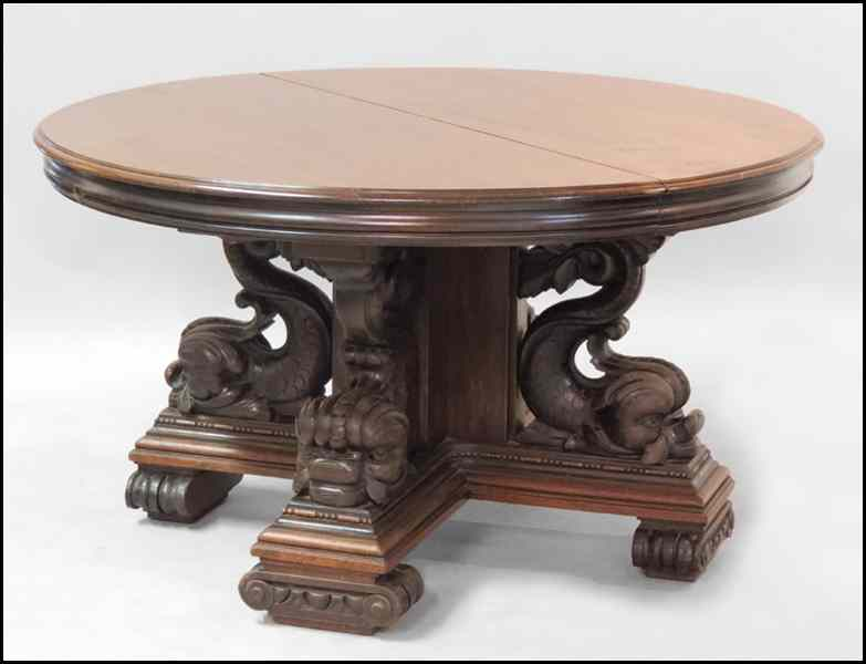 LATE 19TH CENTURY CARVED WALNUT DINING TABLE Raised on a