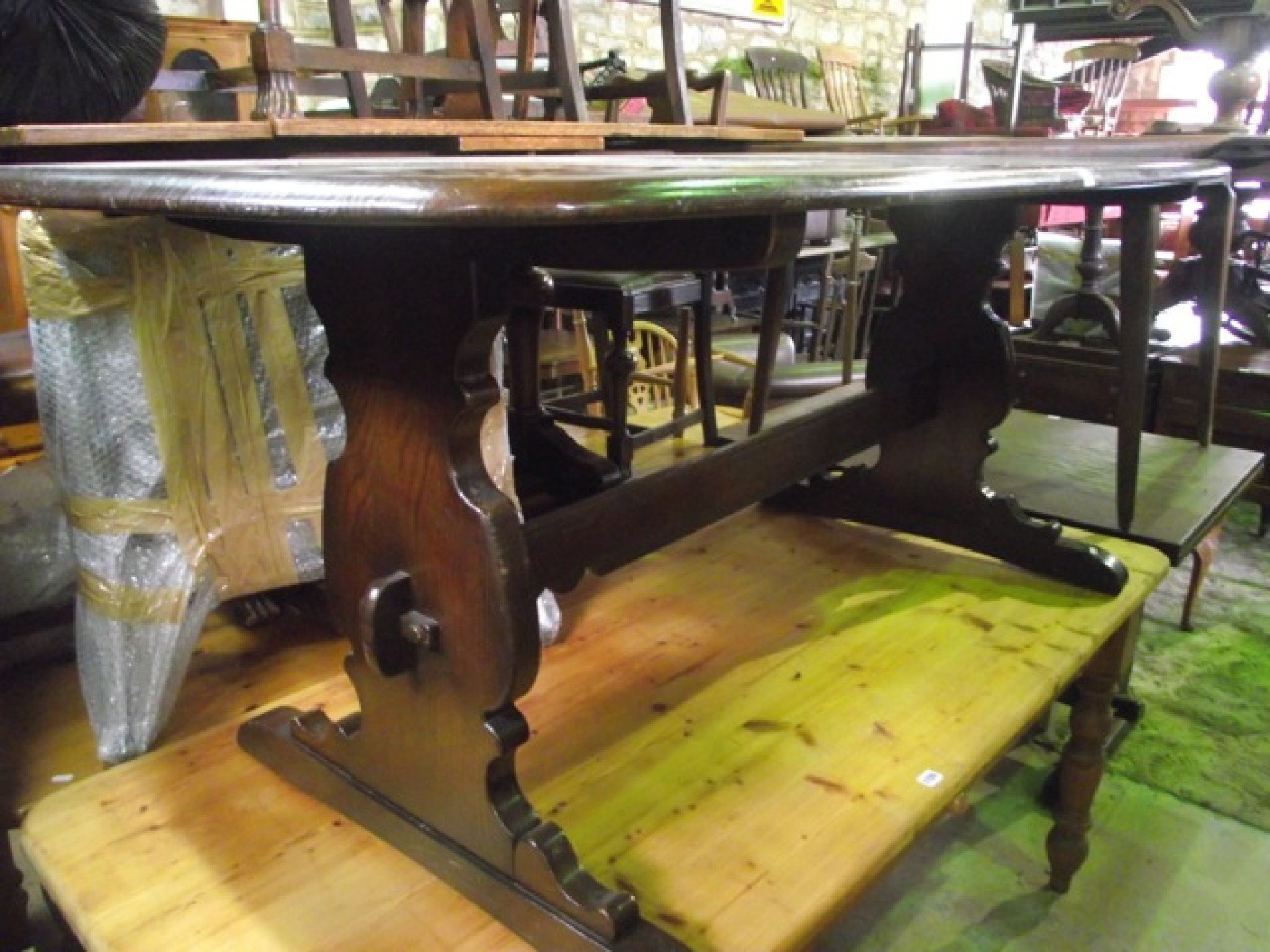 An Ercol dark elm refectory dining table of rectangular form