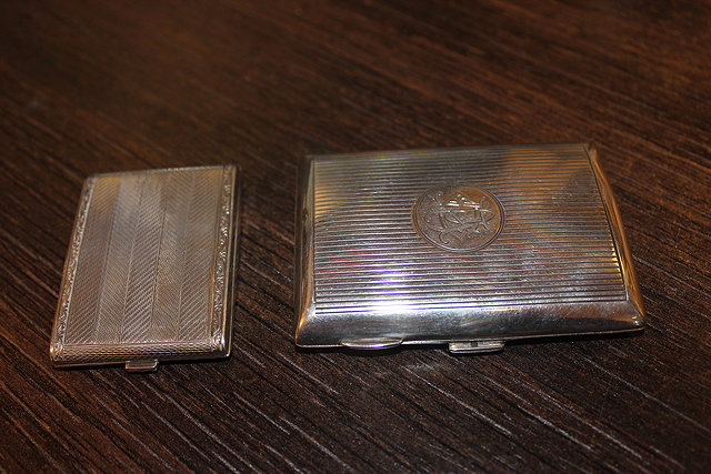 A SMALL SILVER CIGARETTE CASE together with a silver match