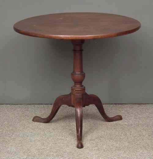 A George III mahogany circular tripod table with solid one