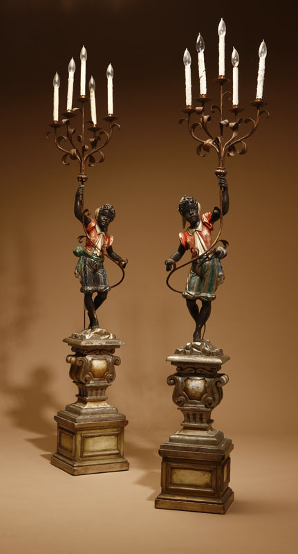 A pair of Italian Rococo style polychrome decorated blackamoor torchieres