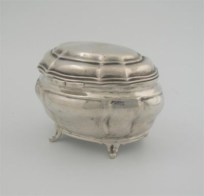 An Edwardian tea caddy of bombe form shaped oval outline