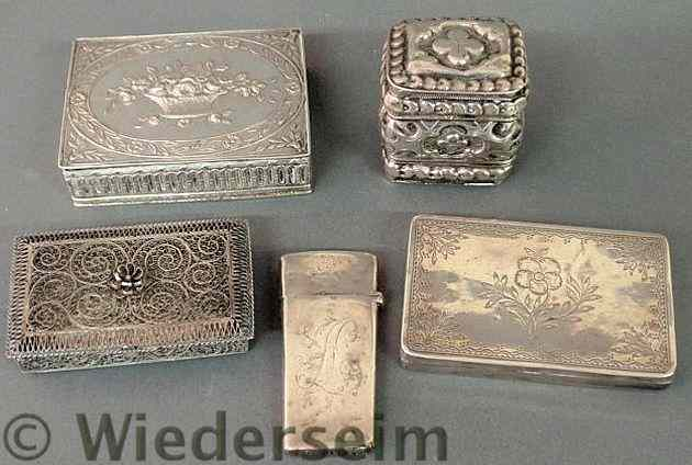 Four small silver boxes and a silver cased nail pick