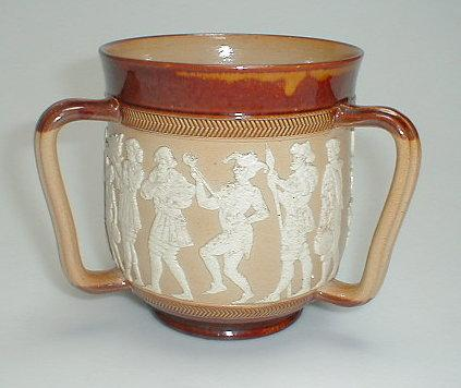 A Doulton Lambeth stoneware Tyg applied with Chaucer like figures
