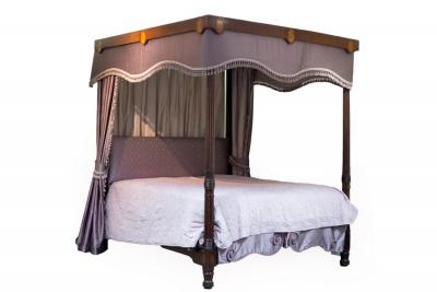 A 19th Century mahogany four poster bed the reeded front