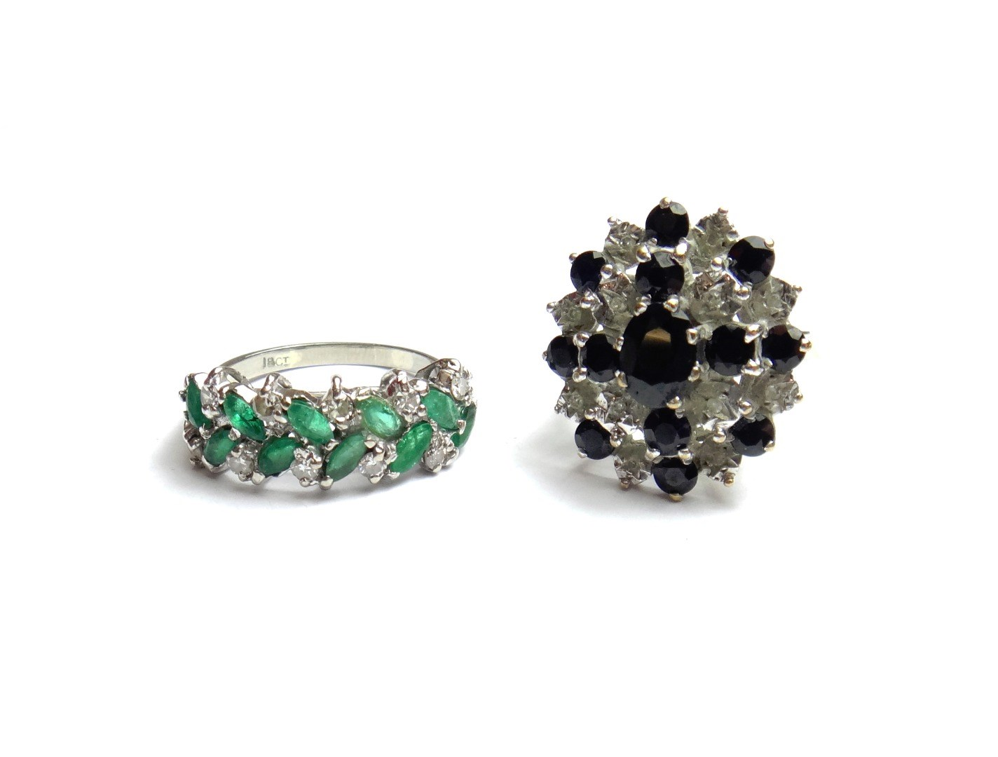 A white gold emerald and diamond set half hoop ring
