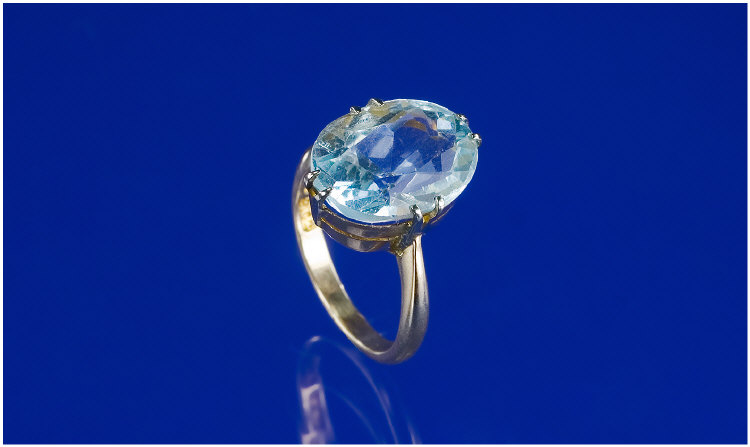 9ct Gold Ring Set With A Blue Oval Faceted Stone