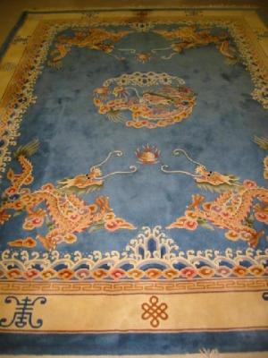 A CHINESE WASHED AND FRINGED RUG 20th century the central
