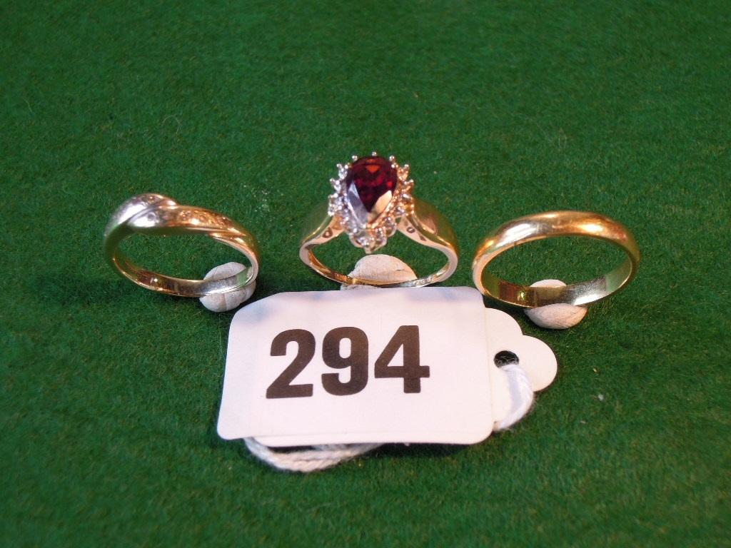 Three rings an 18ct yellow gold plain band ring a