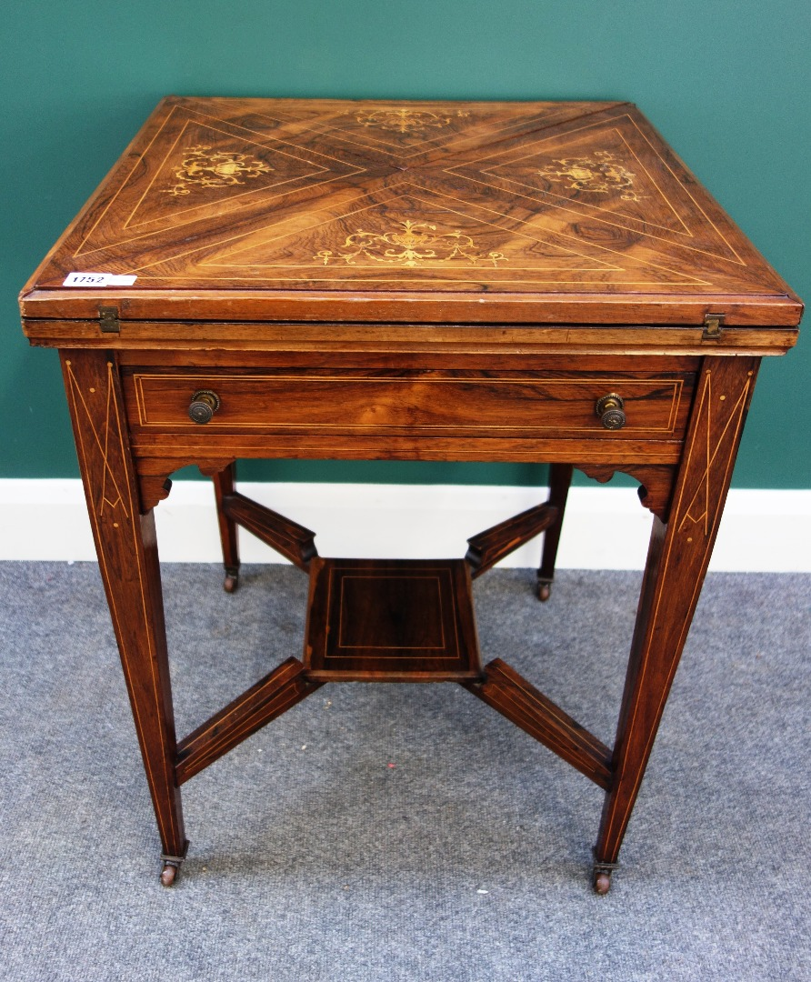 A late Victorian marquetry inlaid rosewood envelope card table with