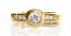 An 18ct gold round brilliant cut diamond solitaire ring total