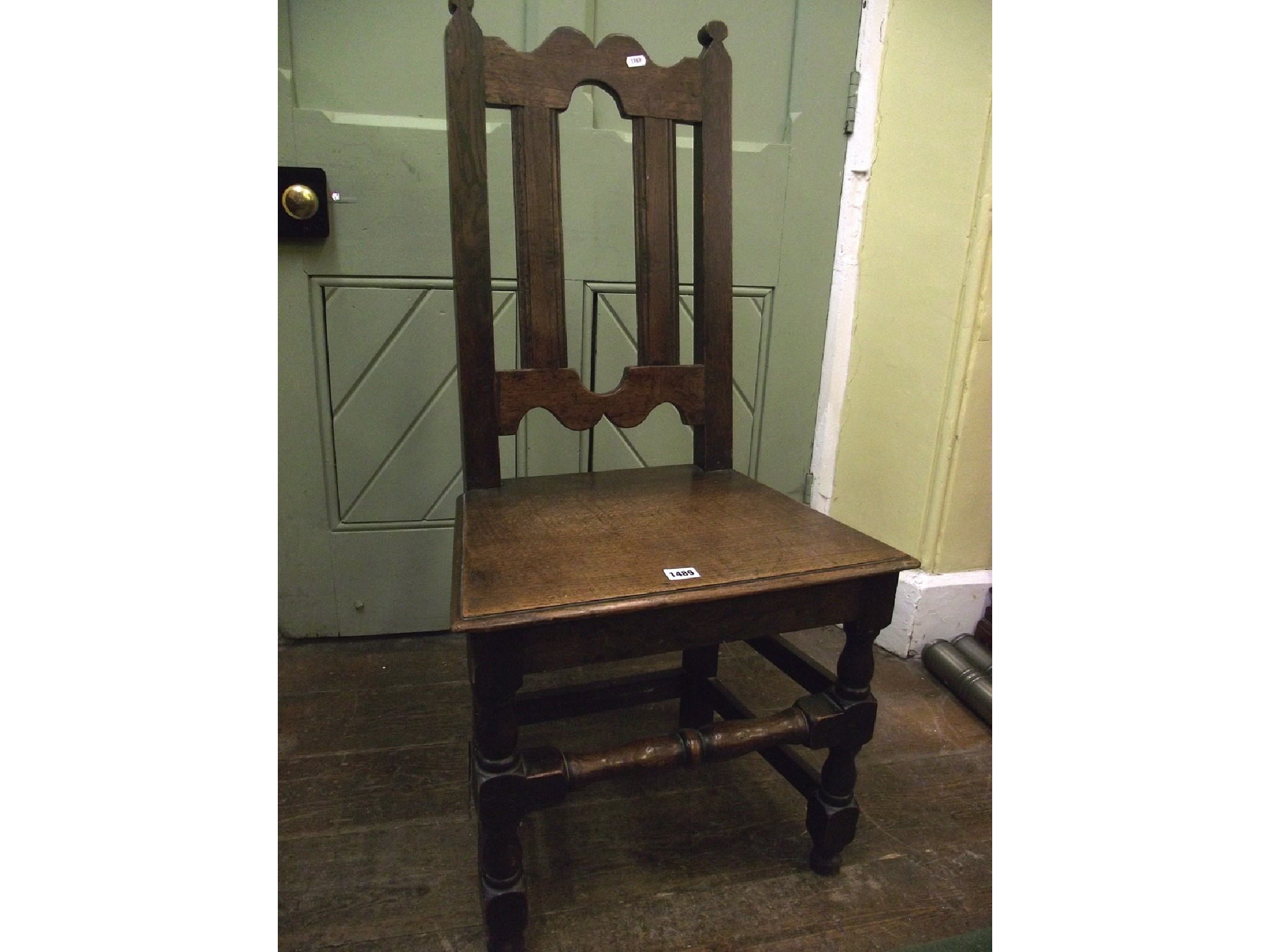 An 18th century oak wainscot chair of simple construction with