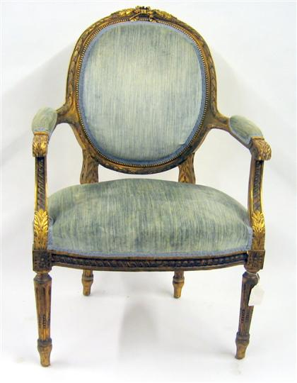 Louis XV style giltwood armchair The oval upholstered back with