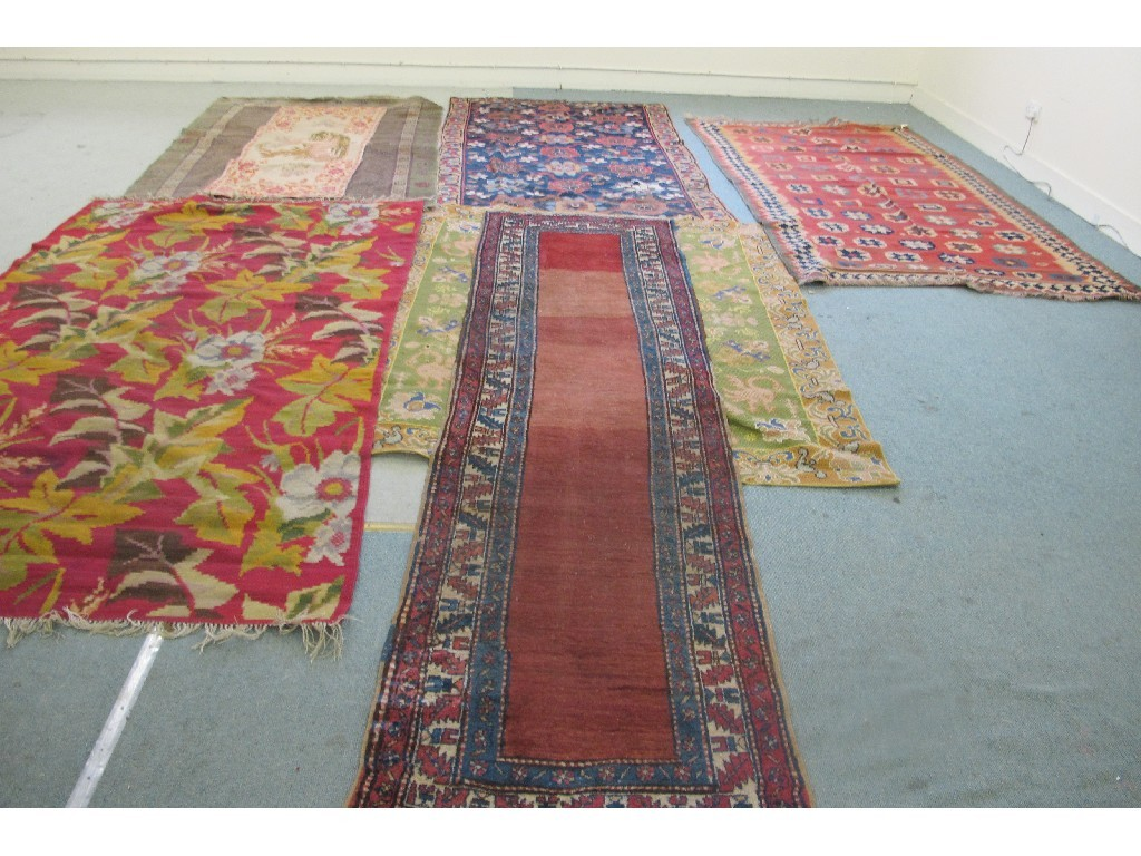 Five assorted Eastern floor rugs and two runners with foliate