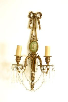 A pair of gilt brass twin branch wall lights in