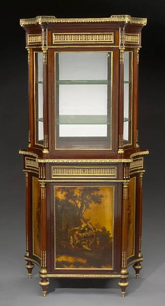 A Louis XVI style gilt bronze mounted mahogany cabinet fourth