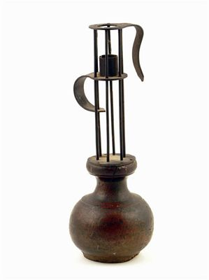 A wrought iron birdcage candlestick the adjustable sconce on a