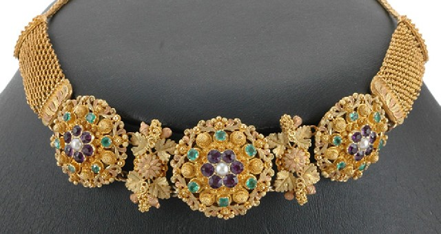 A Suffragette necklace Comprising three floral links set with seed