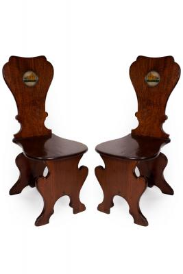 A pair of early George III mahogany sgabello hall chairs
