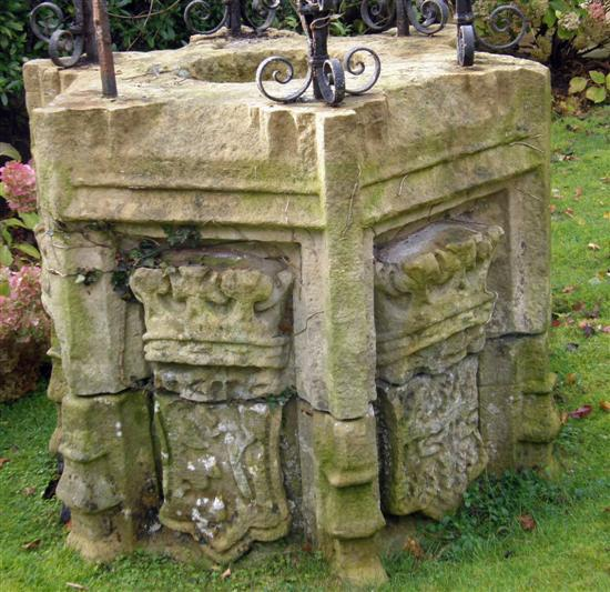 Hexagonal carved stone well head carved in relief with alternating
