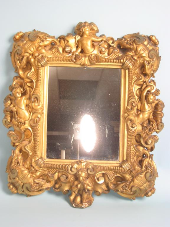 An 18th Century carved giltwood Mirror with cherubs dragon masks