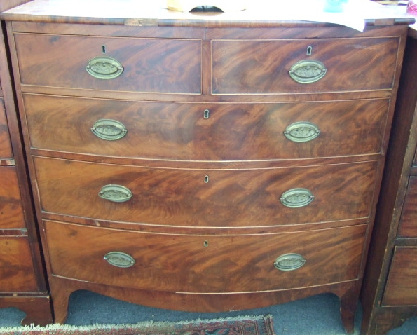 A Regency mahogany bowfront chest of two short and three