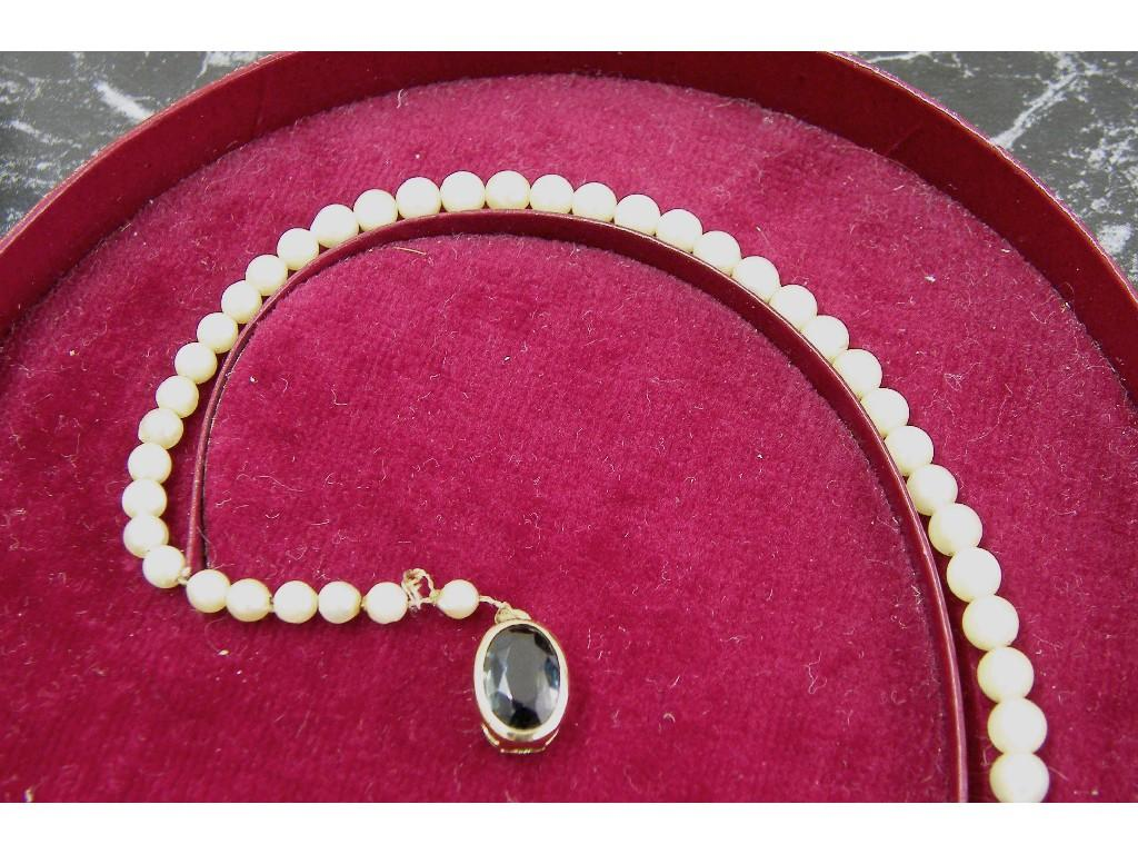 String of graduated cultured pearls with a blue gem set