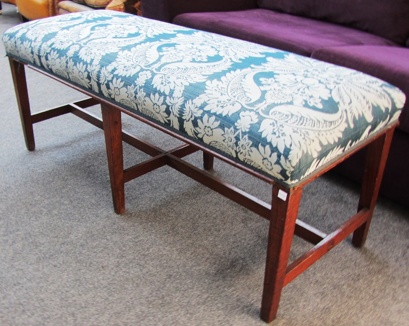 A George III and later mahogany framed long stool of