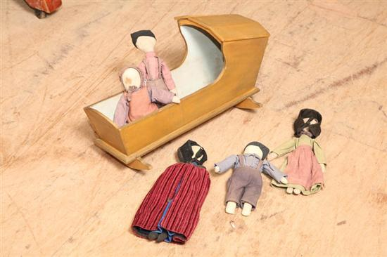 FIVE AMISH DOLLS AND A CRADLE A boy with purple