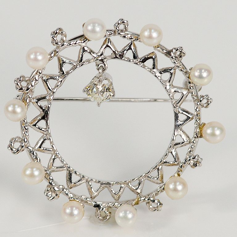 14 karat circular pin set with pearls and dangle diamonds