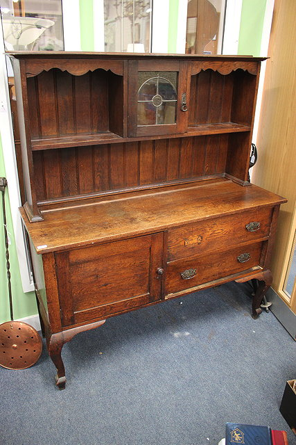 AN EARLY 20TH CENTURY OAK DRESSER enclosed back with recesses
