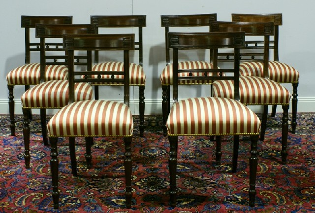 A set of eight Regency style mahogany and upholstered dining