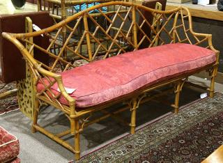 McGuire style rattan settee having an openwork back continuing to