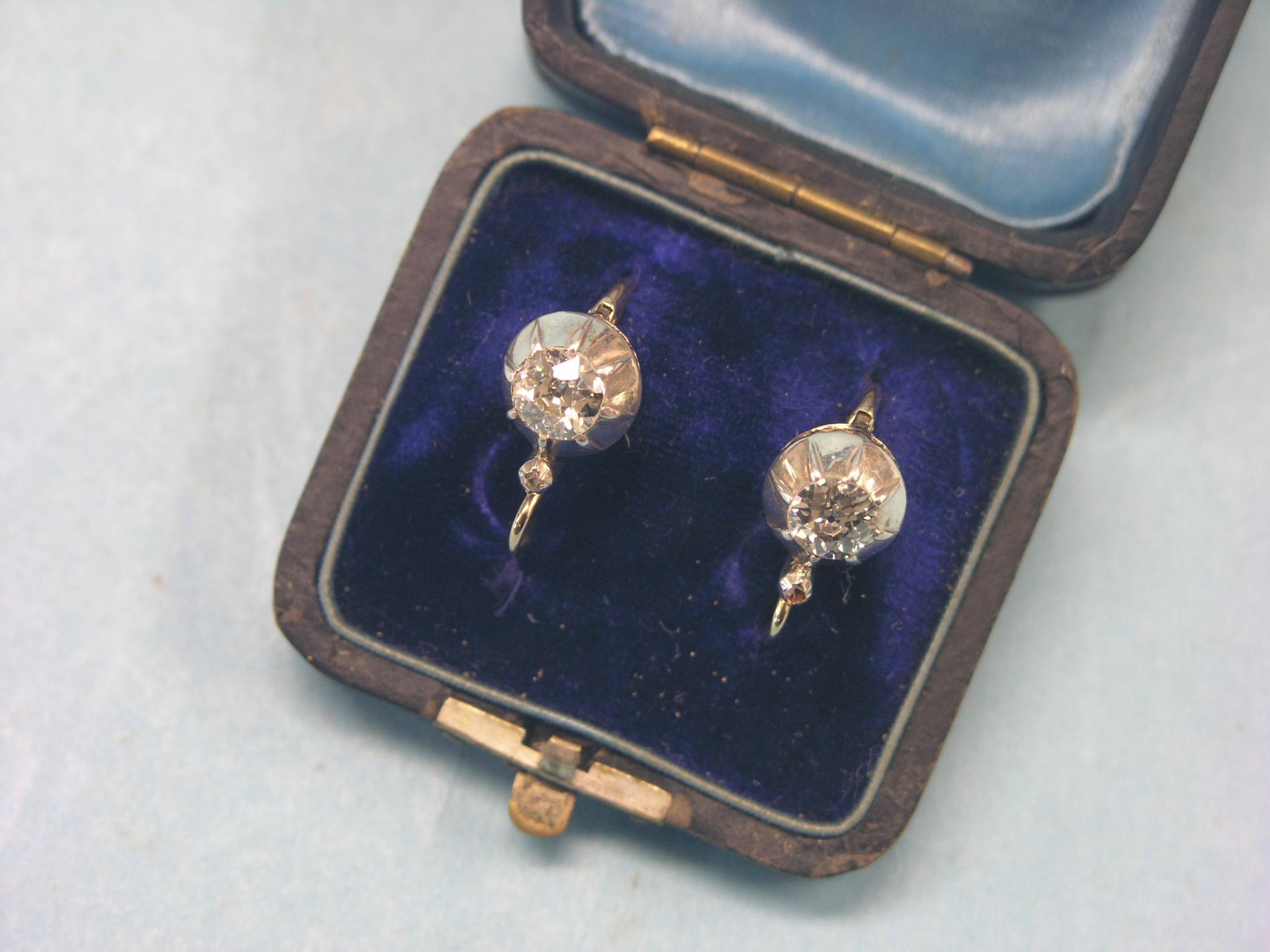 A pair of diamond solitaire ear rings each stone approx