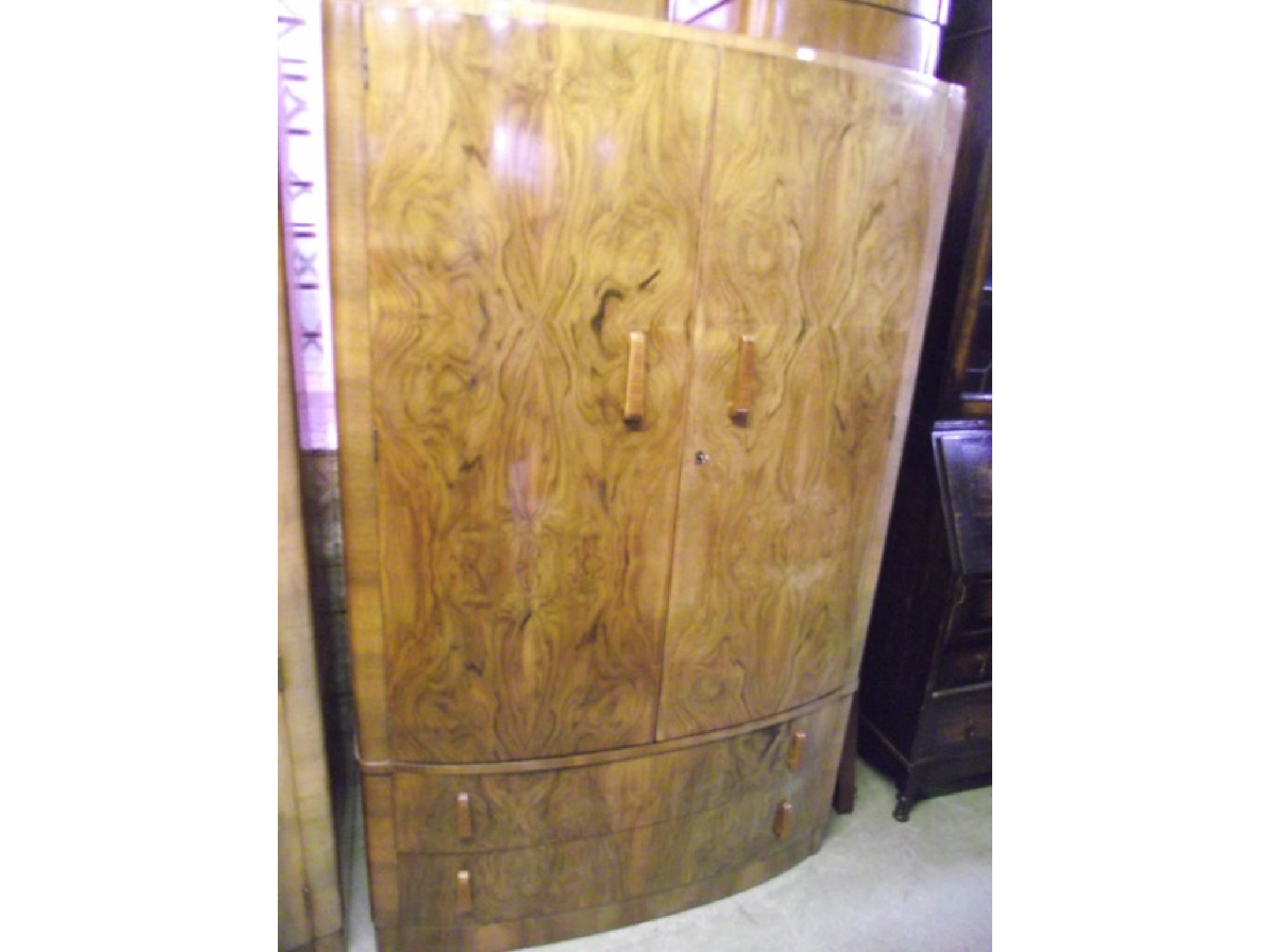 An Art Deco style walnut and figured walnut veneered bow