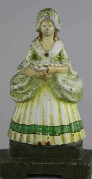 LADY HOLDING FRUIT DOORSTOP Judd Co depicts lady on base