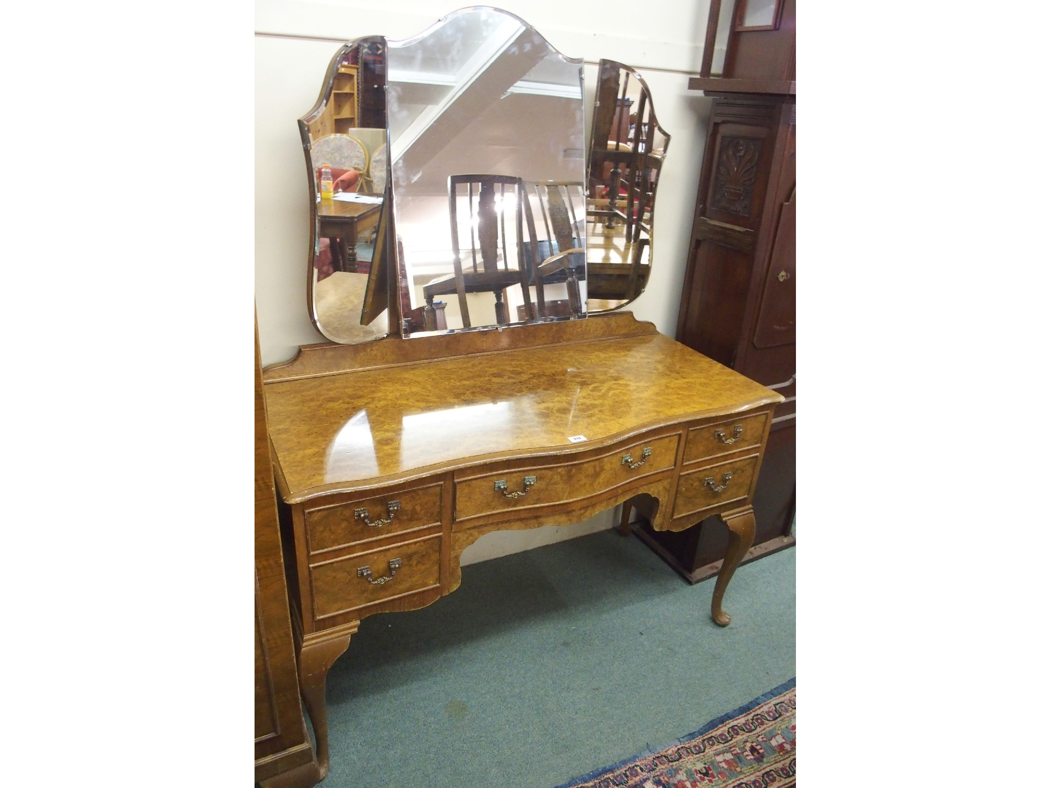 A 20th Century walnut bedroom suite comprising serpentine dressing table