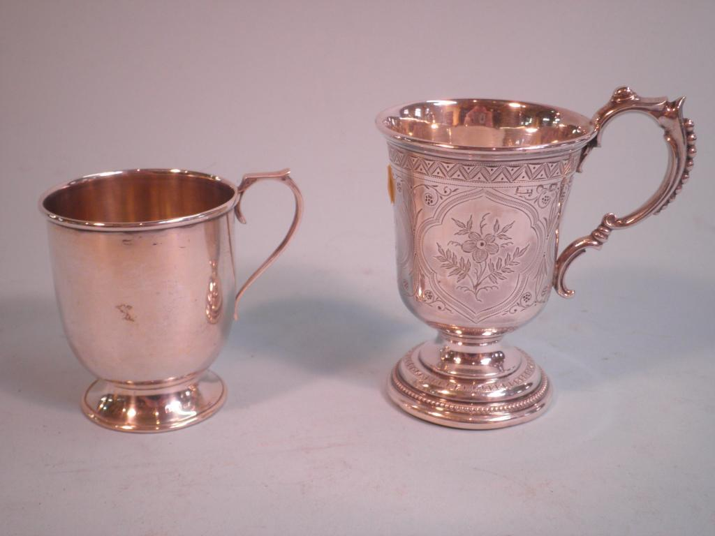 A Victorian silver christening mug the scroll handle cast with