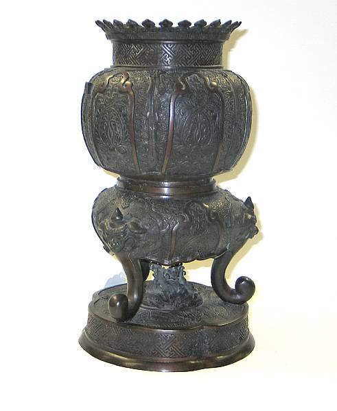 A cast bronze pieced censer The globular pomegranate shaped body