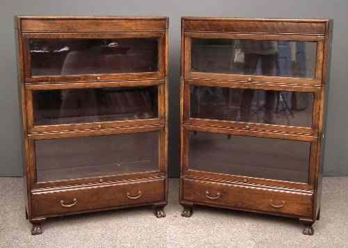 Two 1920s stained wood three tier sectional bookcases with glazed