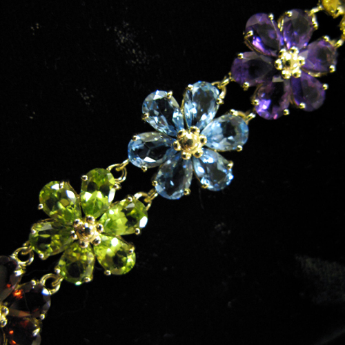 MULTI COLOR GEMSTONE AND FOURTEEN KARAT GOLD DAISY MOTIF BRACELET